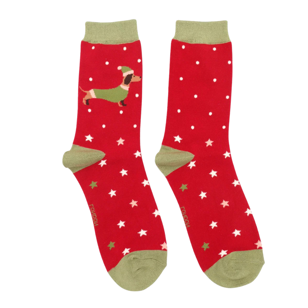 
                      
                        A pair of socks depicting a festive sausage dog with a star pattern. Red legs, gold toe, heel and cuff. 
                      
                    