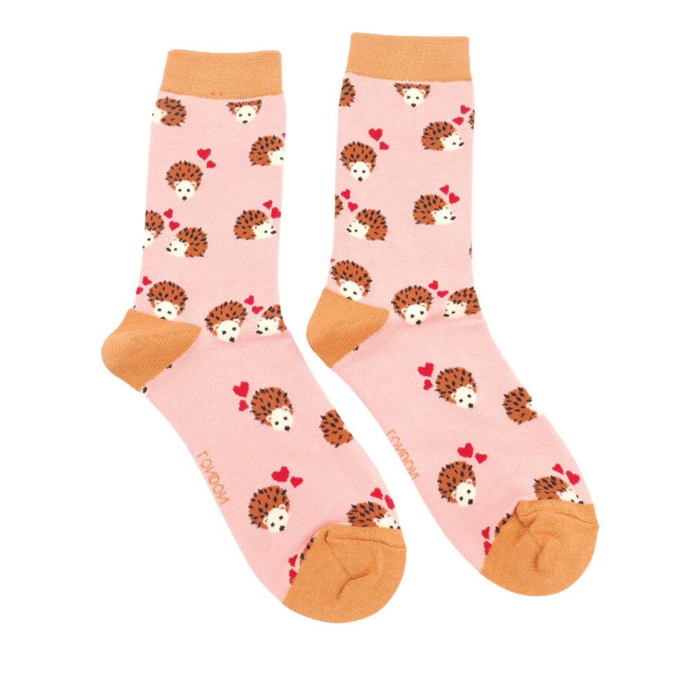 
                      
                        Hearts and Hedgehogs Bamboo Socks. A pair of socks with a hedgehog and hearts motif. Pink legs, orange heel, toe and cuff. 
                      
                    