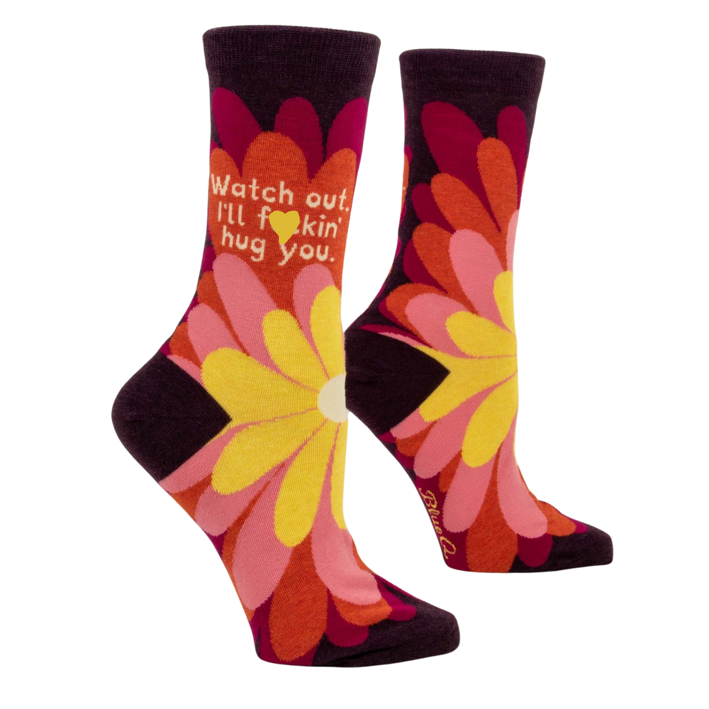 Watch Out I'll F**king Hug You Socks. A pair of socks that have a flower motif and a sweary slogan. 