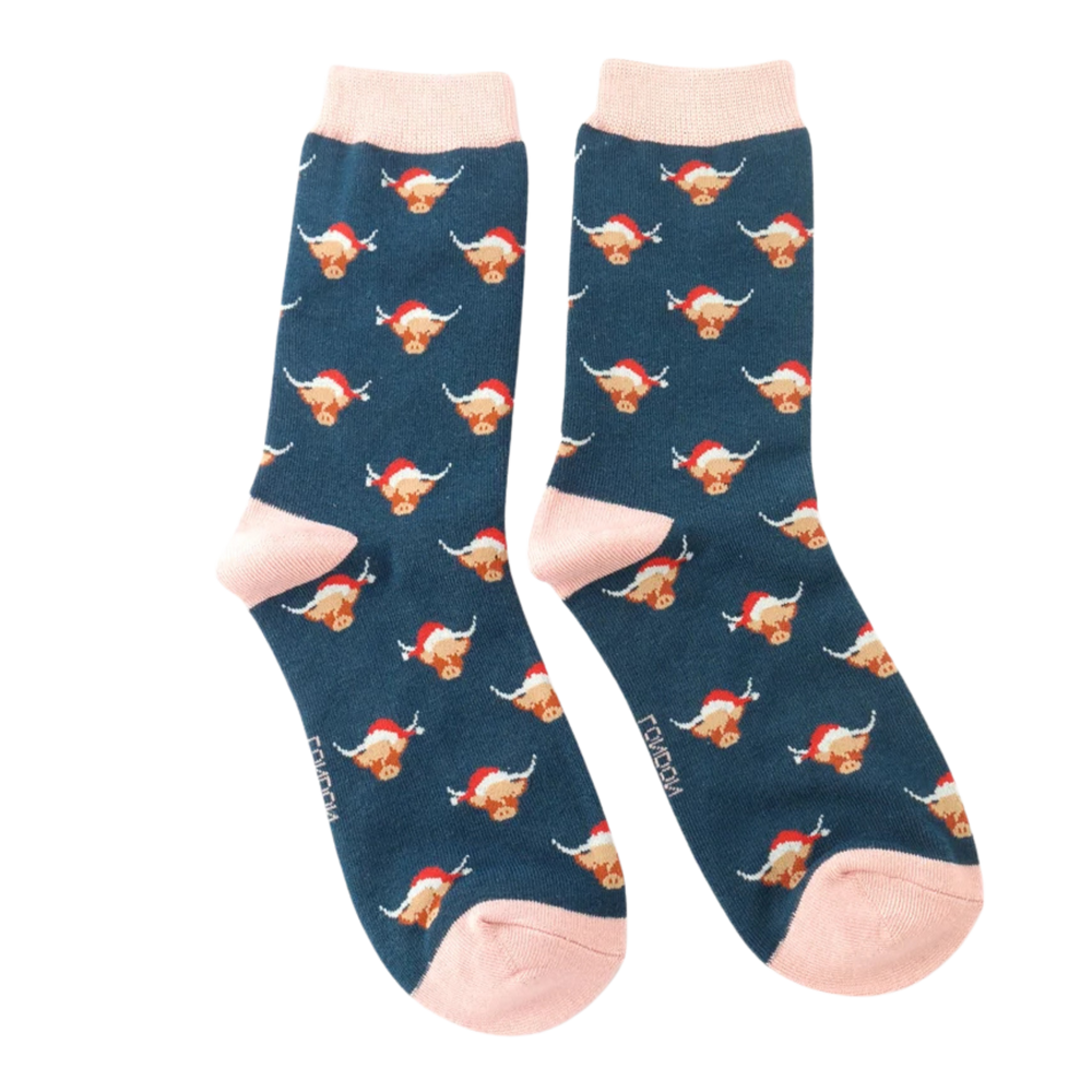 Xmas Highland Cow Bamboo Socks - Miss Sparrow. A pair of socks with a festive highland cow pattern. Dark blue legs, pink heel, toe and cuff. 