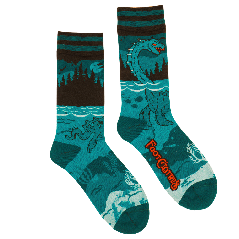 
                      
                        Nessie Socks. A pair of socks featuring the Loch Ness Monster. Blue legs, blue heel, toe and cuff. 
                      
                    