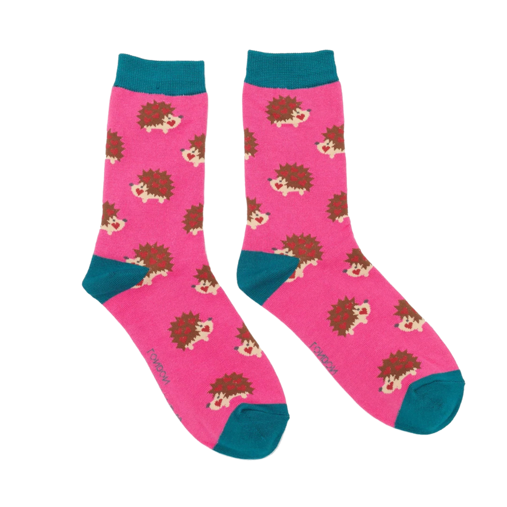 A pair of socks with a hedgehog motif. Hot pink legs, teal heel, toe and cuff. 