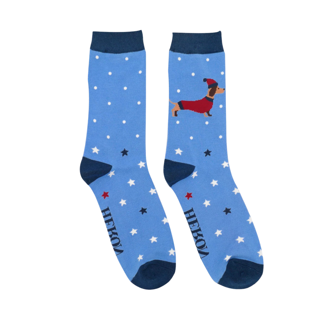 
                      
                        A pair of socks depicting a festive sausage dog with a star pattern. Blue legs, dark toe, heel and cuff. 
                      
                    