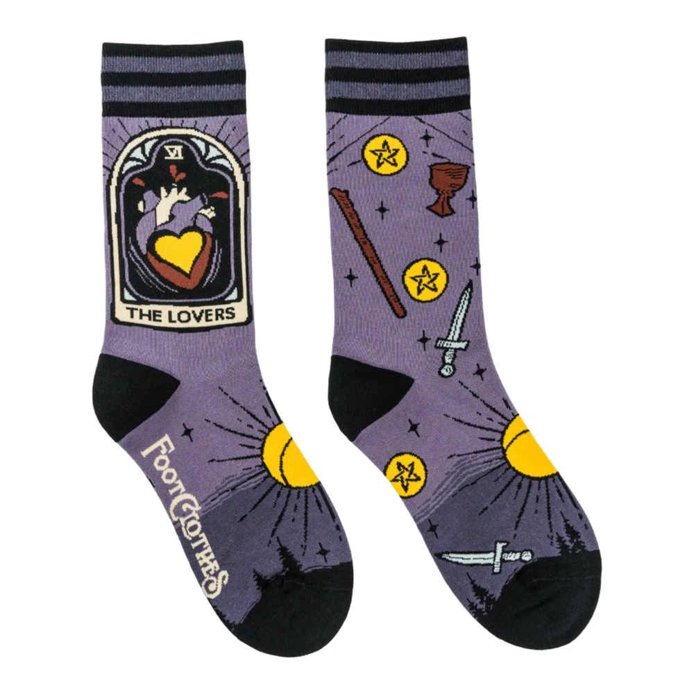 
                      
                        The Lovers Tarot Nouveau Crew Socks. A pair of socks depicting the lovers tarot card and tarot symbols. Purple legs, black heel toe and cuff. 
                      
                    