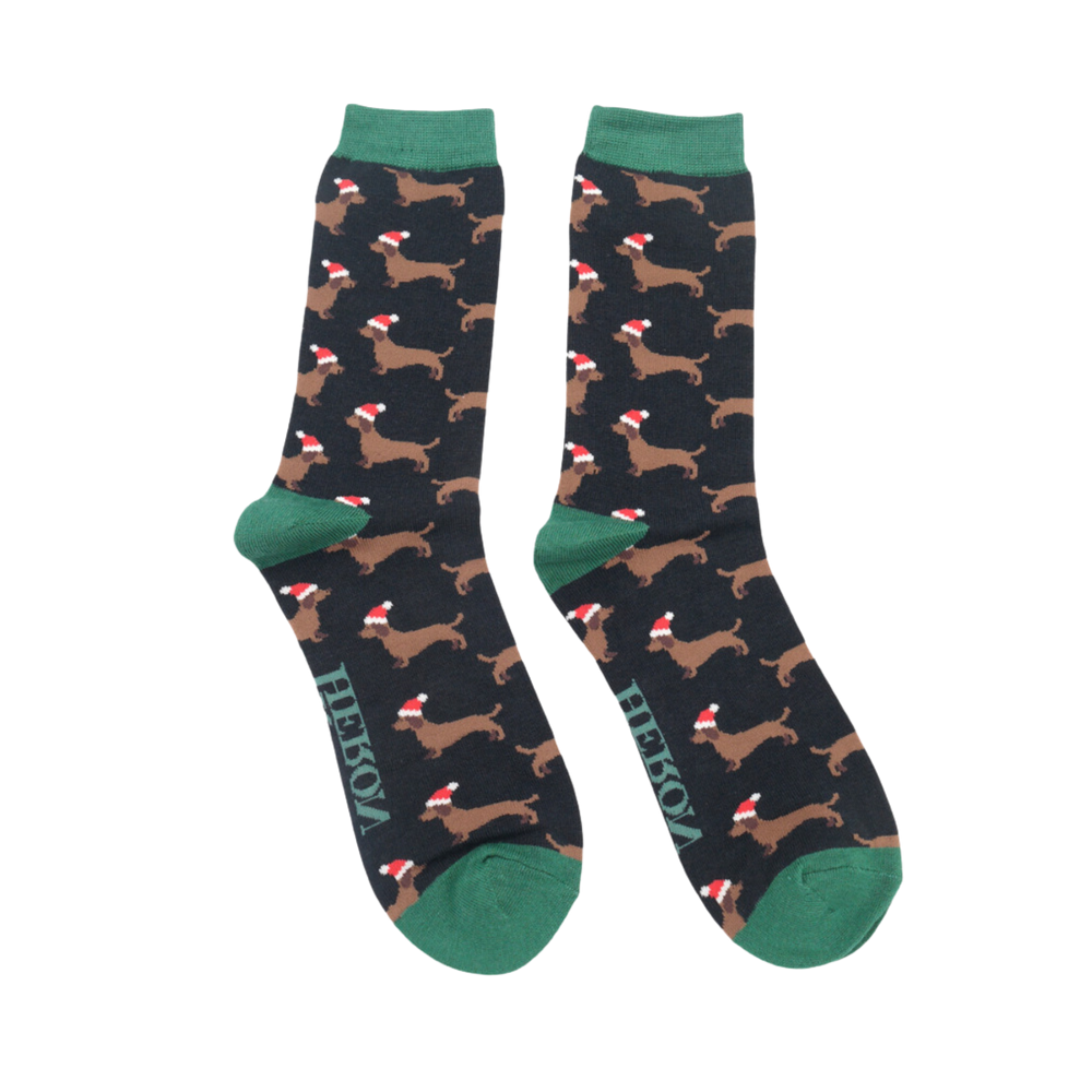 
                      
                        A pair of socks depicting sausage dogs wearing santa hats. Black legs. Green heel, toe and cuff. 
                      
                    