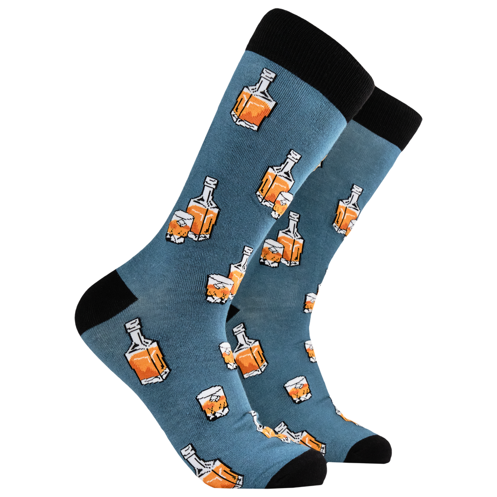 Whiskey Bamboo Socks. A pair of socks depicting whiskey in a glass and bottle. Blue legs, black heel, toe and cuff. 