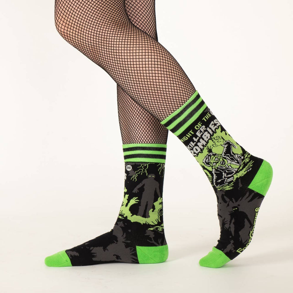 
                      
                        A model wearing a pair of socks depicting classic zombie imagery. Green toe, heel and cuff. 
                      
                    