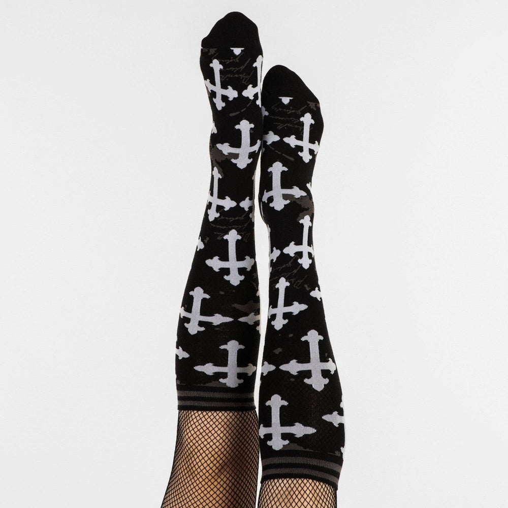 
                      
                        A pair of knee high socks with a gothic cross pattern. Black and white. 
                      
                    