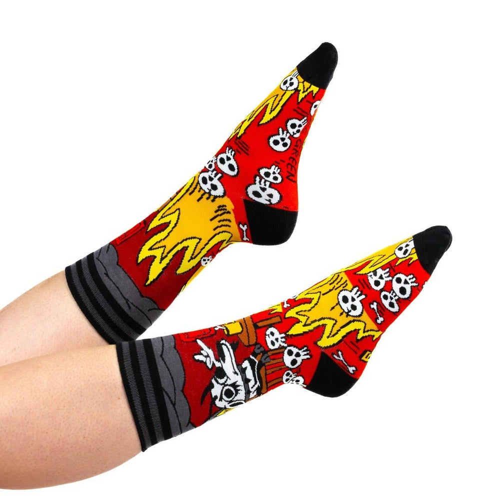 
                      
                        A model wearing a pair of socks featuring a design by KC Green. Red flaming legs, black legs, heel, toe and cuff. 
                      
                    