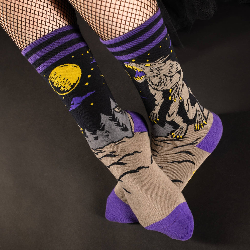 
                      
                        A model wearing a pair of socks featuring an evil werewolf design. Grey legs, purple heel, toe and cuff. 
                      
                    