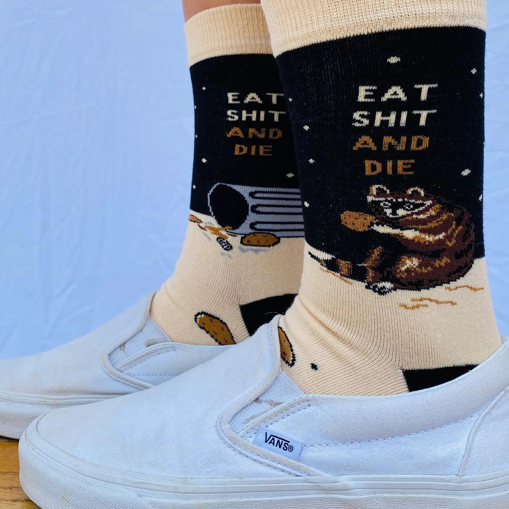 
                  
                    Model wearing a pair of socks with a bold slogan and racoon eating out of the bin detail. Black toe, cuff and heel.
                  
                