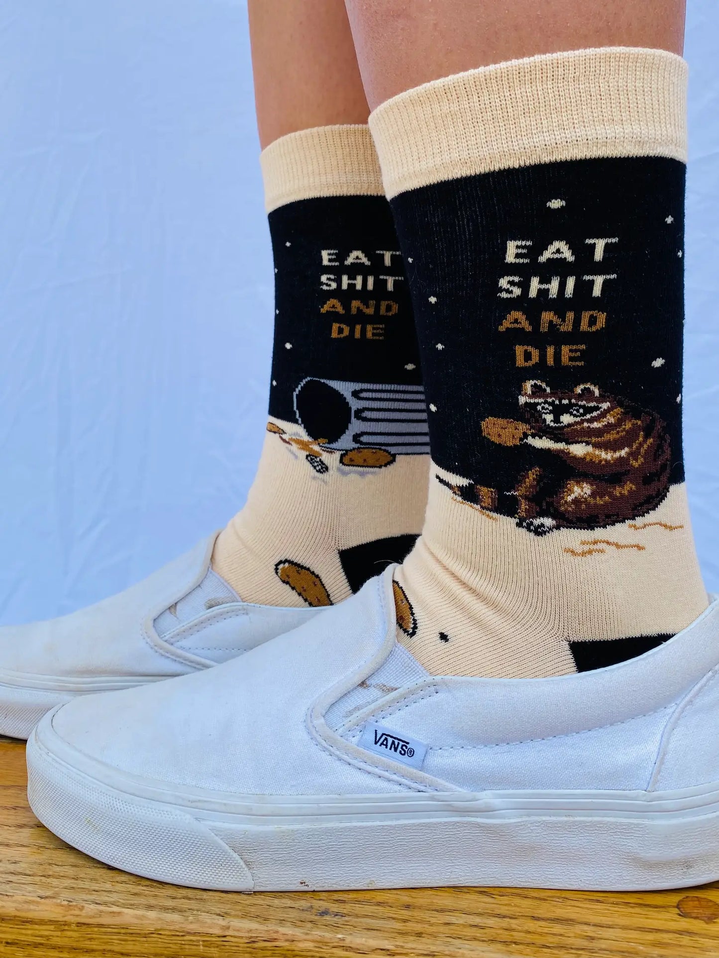 
                  
                    Model wearing a pair of socks with a bold slogan and racoon eating out of the bin detail. Black toe, cuff and heel.
                  
                