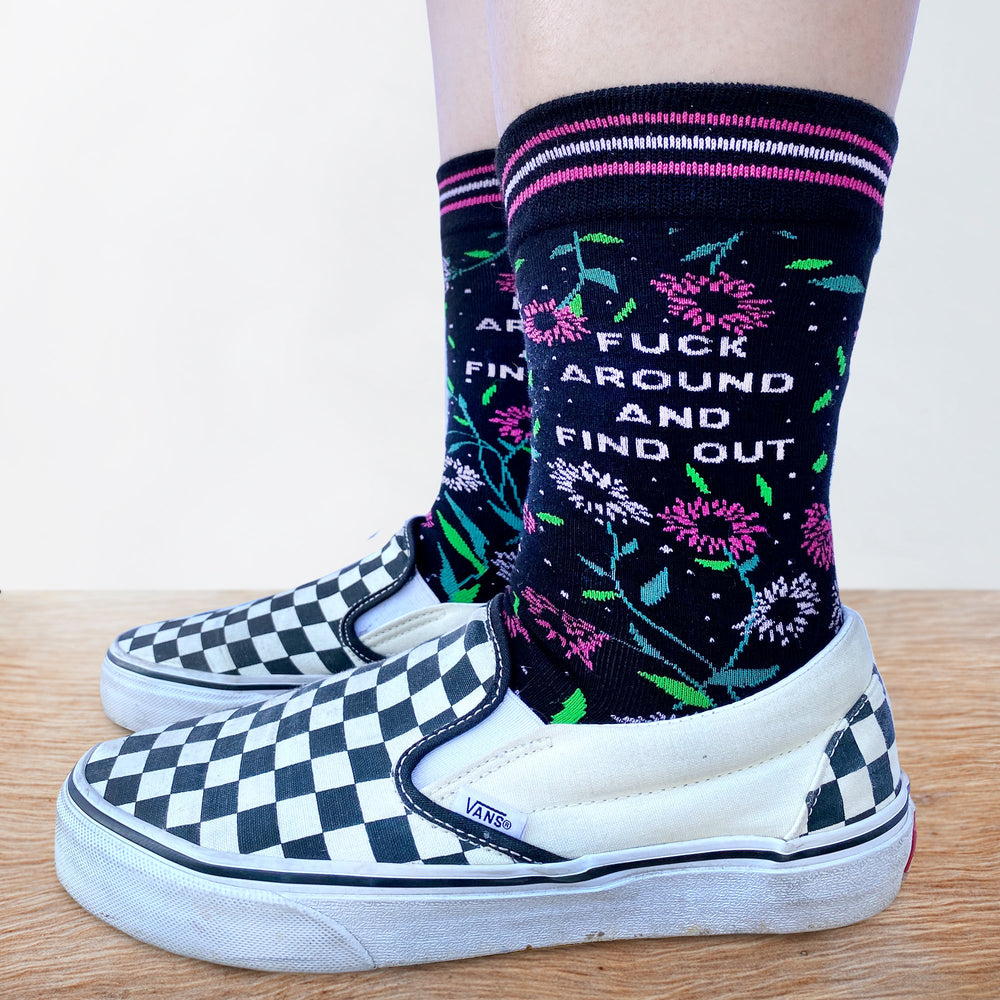 
                      
                        Model wearing a pair of socks with a bold slogan and pink floral details. Pink toes, cuff and heel.
                      
                    