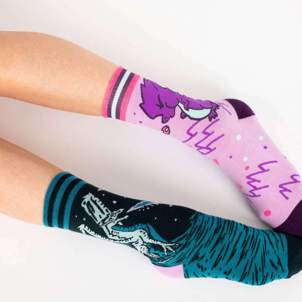 
                      
                        A model wearing a pair of socks featuring a cute dragon motif. Pink legs, purple heel, toe and cuff. 
                      
                    