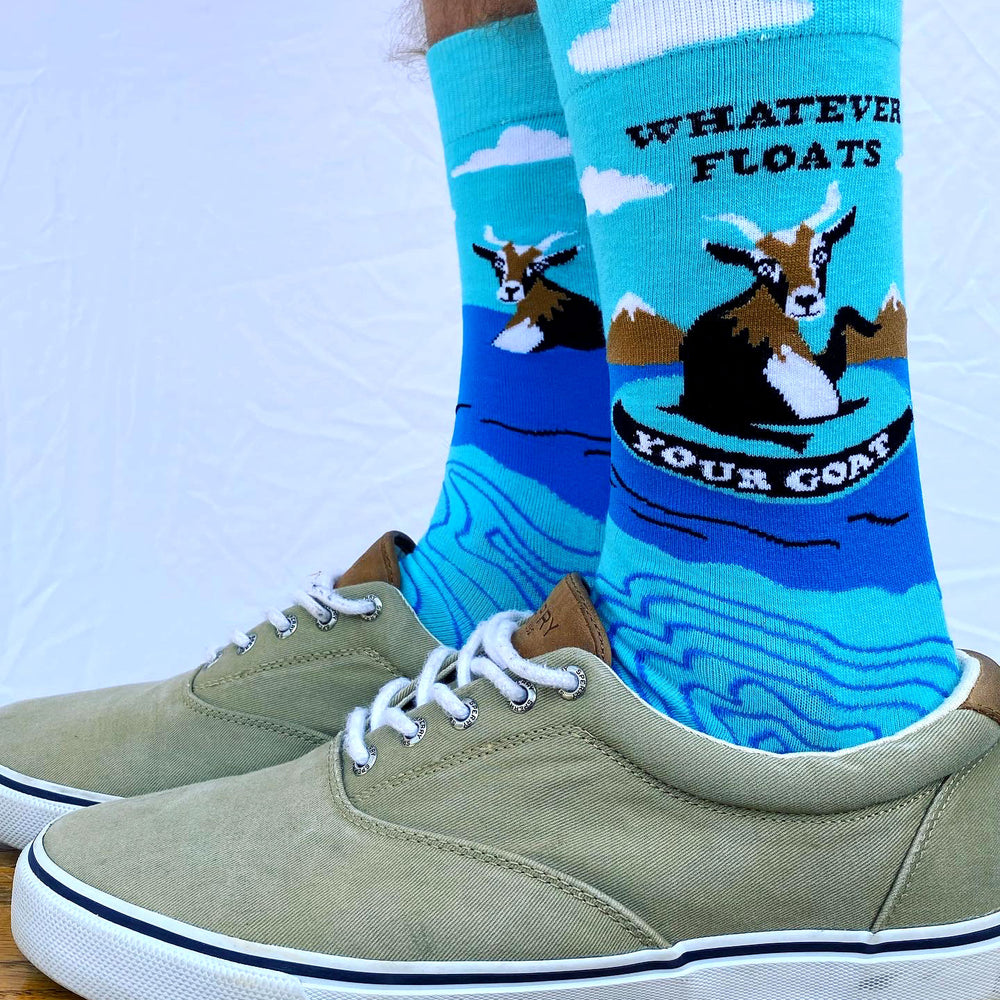 
                  
                    A model wearing a pair of socks depicting a floating goat and a fun slogan. Brown toes, cuffs and heel.
                  
                