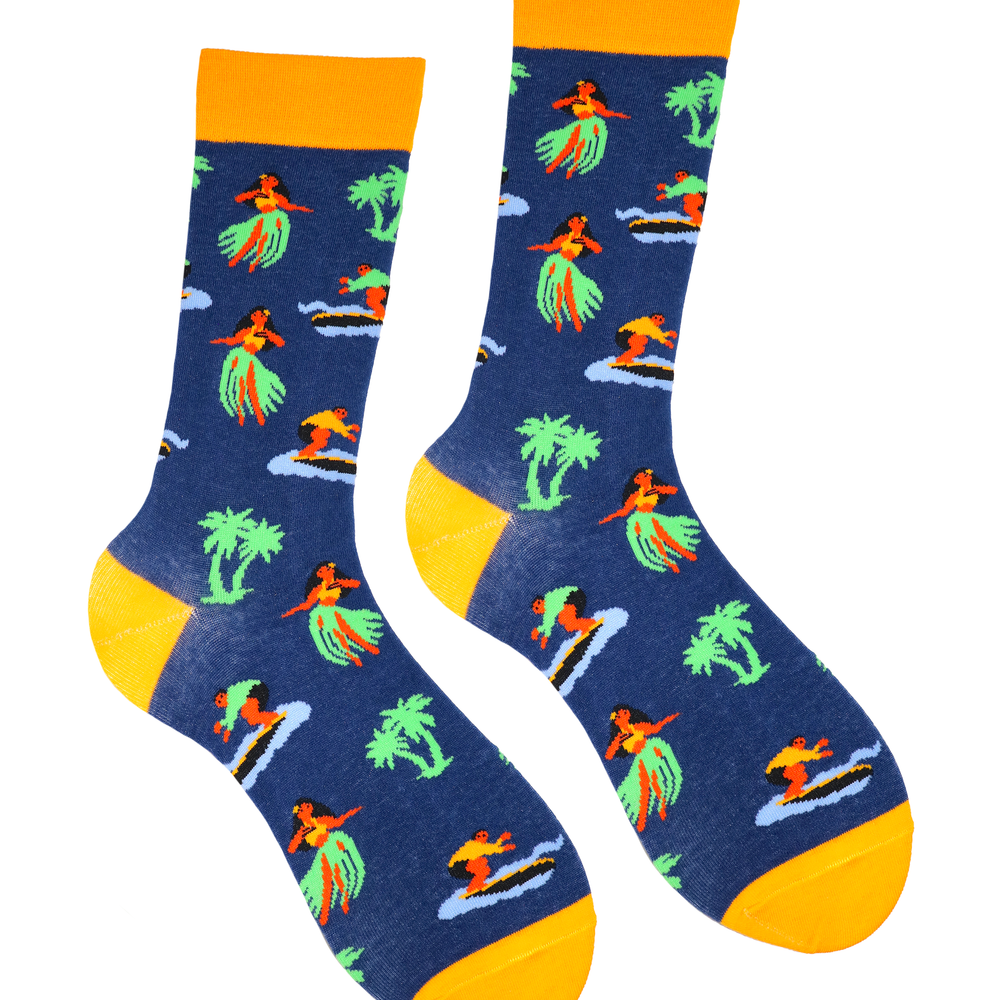 A pair of socks depicting hula girls and surfers. Blue legs, yellow cuff, heel and toe.