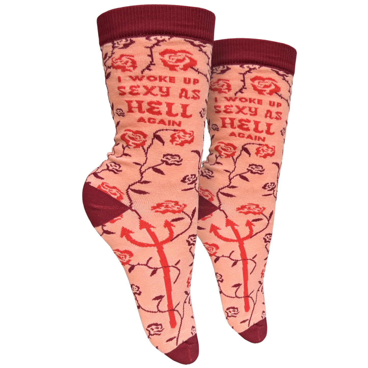 I Woke Up Sexy As Hell Again Slogan Socks. A pair of socks with a rose and devil motif. Pink legs, red cuff, heel, toe and cuff. 